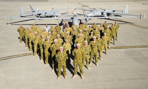 Royal Australian Air Force Air Component Commander Group Captain Tony McCormack stands alongside members of the Heron Remotely Piloted Aircraft Detachment (Rotation 13) following the completion of 20,000 flying hours in Afghanistan