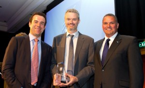 Cathay Pacific's Dominic Perret (left) and Airservices' Rob Walker (right) present Gerard Frawley with the Aviation Journalist of the Year trophy. (Seth Jaworski)