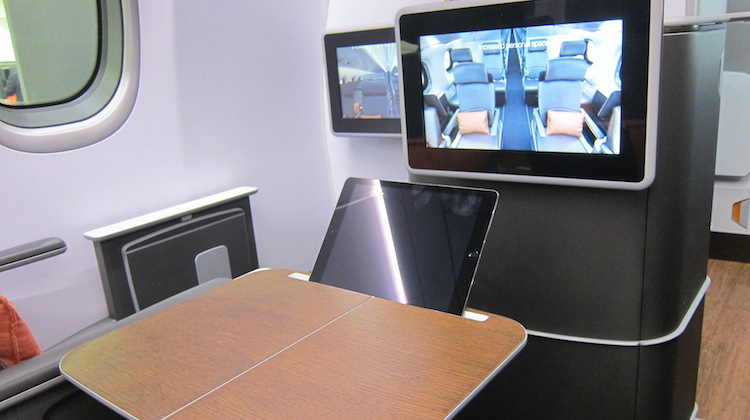 The business class table features a stand for tablet devices. (Jordan Chong)