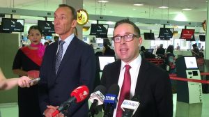 Qantas chief executive Alan joyce speaking with reporters at Sydney Airport. (Jordan Chong)
