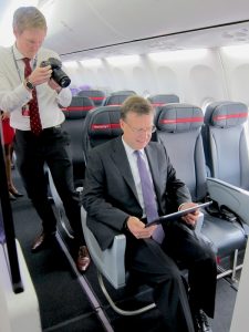 Virgin Australia group executive for airlines John Thomas sitting on a Boeing 737-800 economy X seat. (Jordan Chong) 