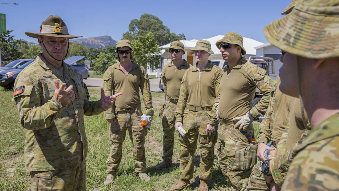 A file image of Major General Greg Bilton speaking with colleagues. (Defence)