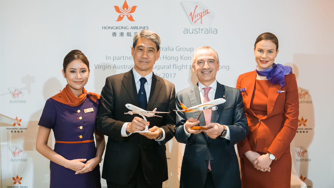 Flight attendants flank Hong Kong Airlines vice chairman Tang King-shing and Virgin Australia chief executive John Borghetti. (Virgin Australia)