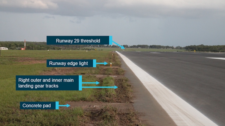Wheel tracks where VH-VUI departed the runway 29 sealed surface and destroyed runway edge lights. (ATSB)