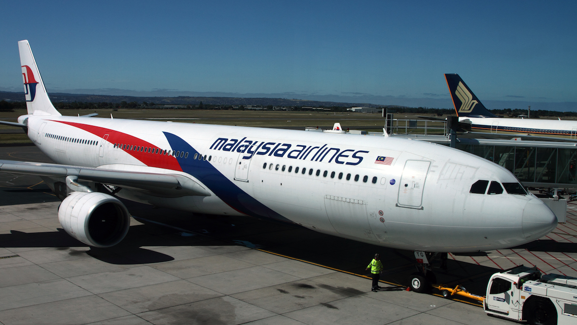 A file image of Malaysia Airlines and Singapore Airlines aircraft side by side at Adelaide Airport. (Rob Finlayson)