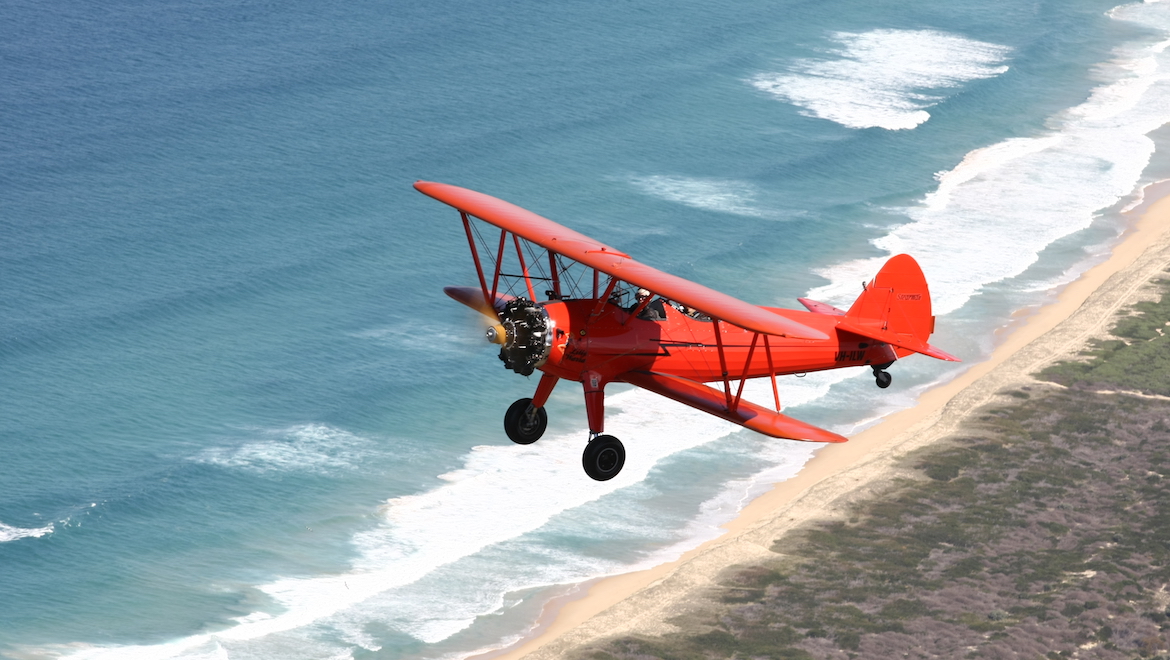The Boeing Stearman VH-ILW in flight off the coast of Wollongong. (Nicholas Eccles)