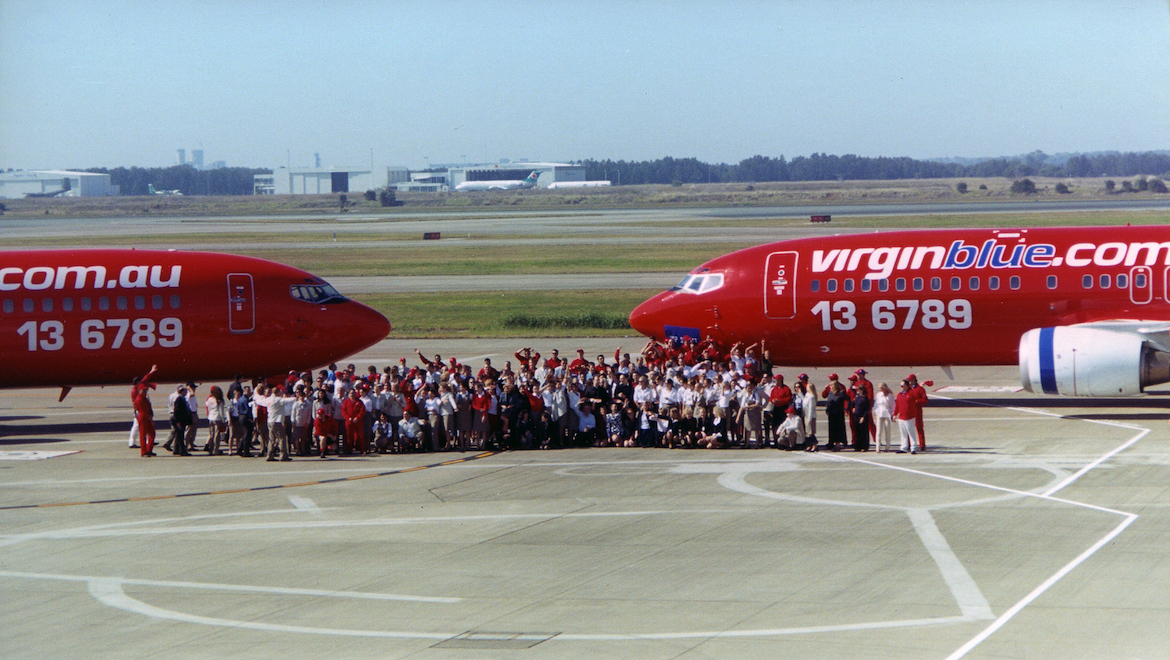 Ready for takeoff – Virgin Blue launched services with two 162-seat ex Virgin Express Boeing 737-400s and about 280 staff on August 31 2000. Those first two aircraft and many of the original workforce are pictured here on the tarmac at Brisbane Airport at the airline’s launch on July 9 that year. (Jim Thorn)