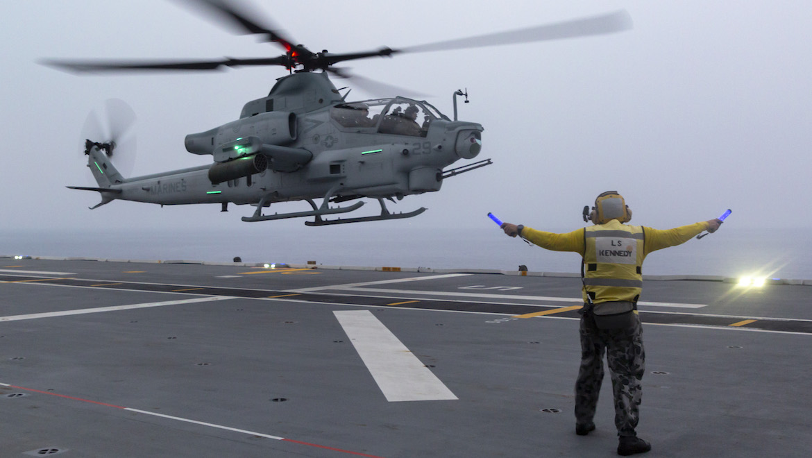 A United States Marine Corps AH-1Z Viper helicopter departing HMAS Adelaide during a multi-spot exercise in 2018. (Defence)