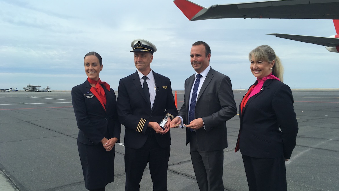 Qantas Captain Robert Nelson hands over the "keys" to the flight deck of 747-400 VH-OJU to Rolls-Royce's Gareth Hedicker at Moses Lake. (Jordan Chong)